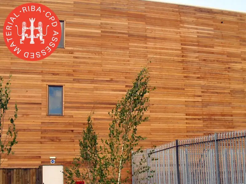 three storey timber clad building, overlaid with the RIBA CPD Assessed Material logo