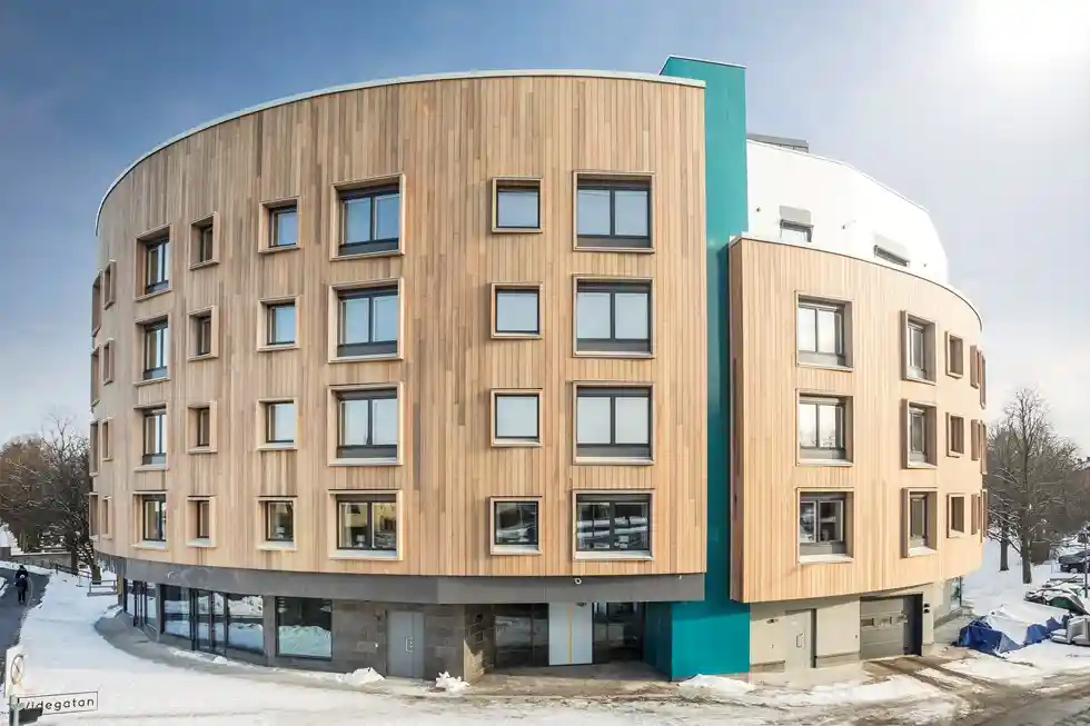 A large circular office block style building clad in timber